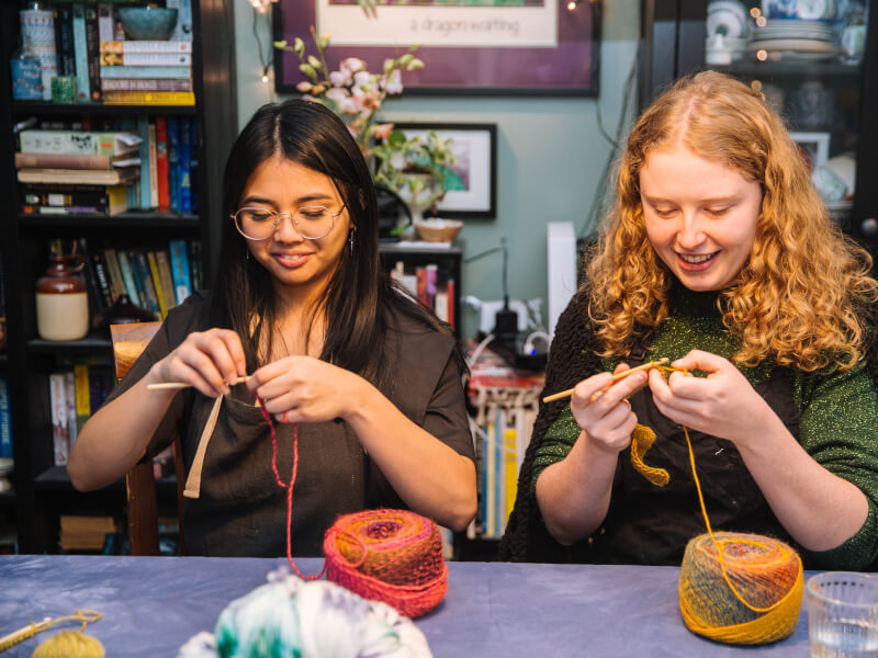 Team members crochet side by side